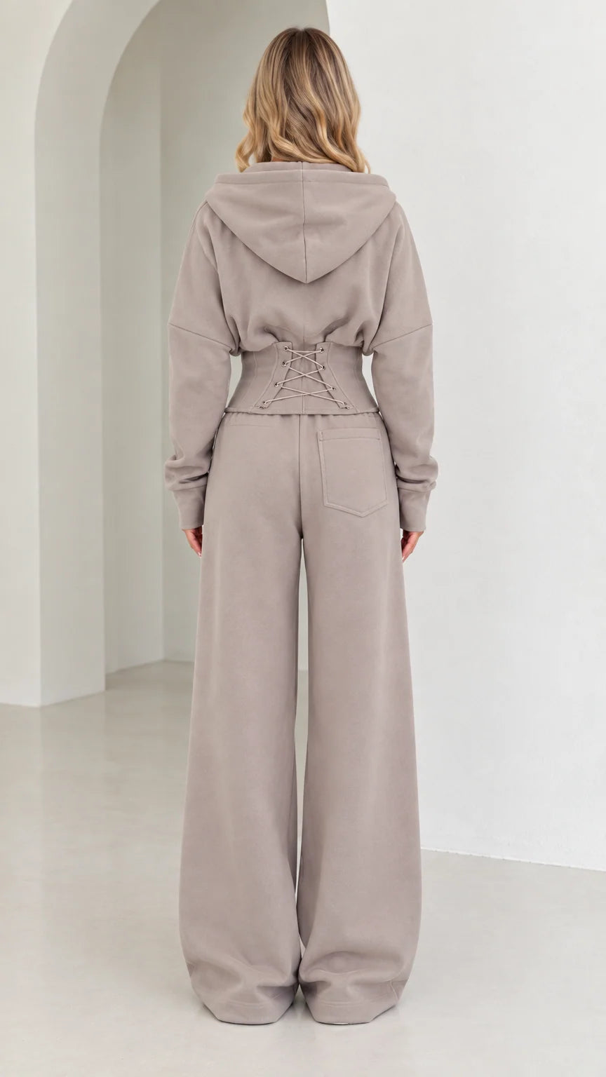 Back view of taupe set highlighting corset lace-up waist detail and wide-leg fit
