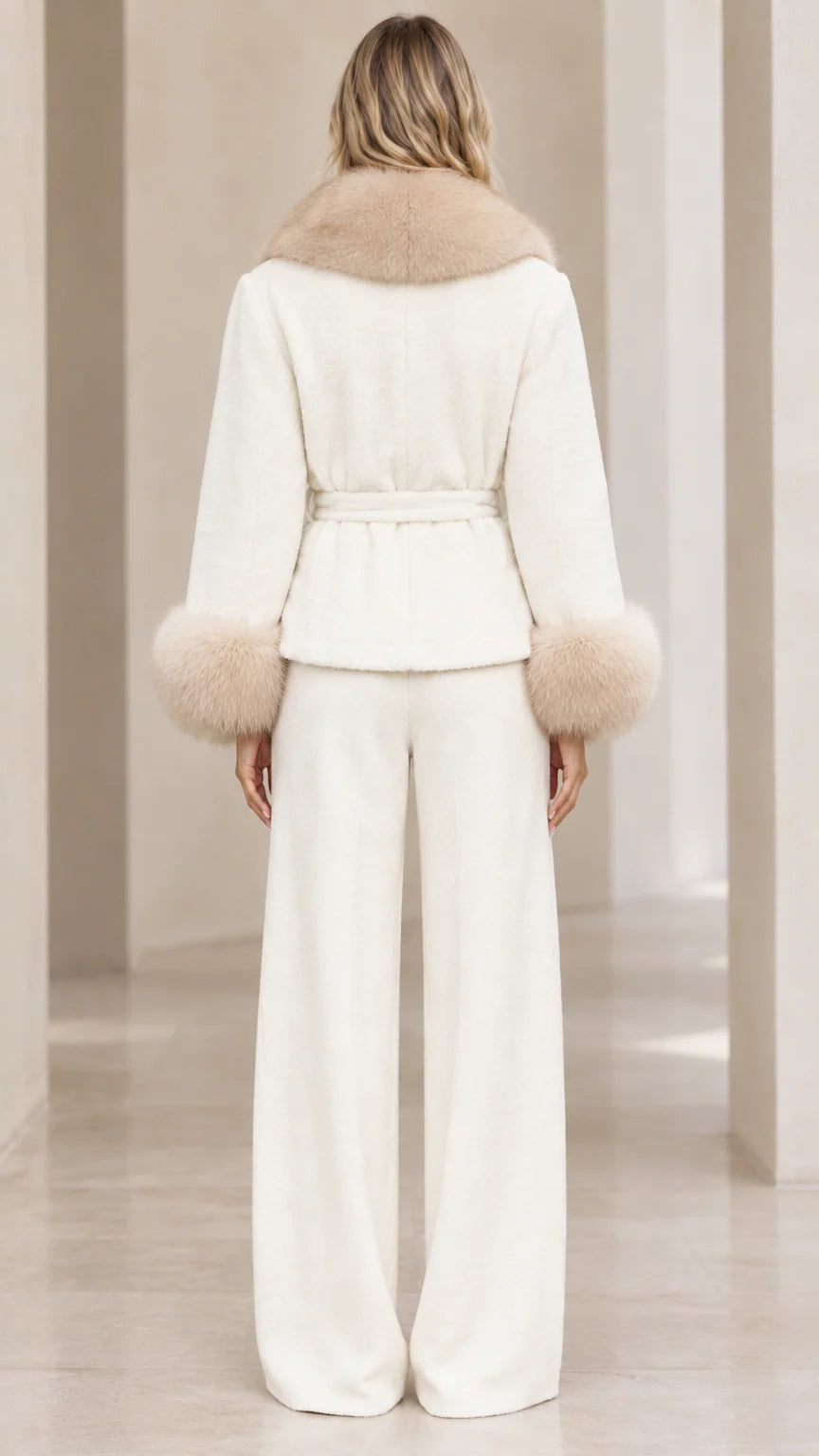 Back view of woman wearing cream belted faux fur collar jacket and trousers