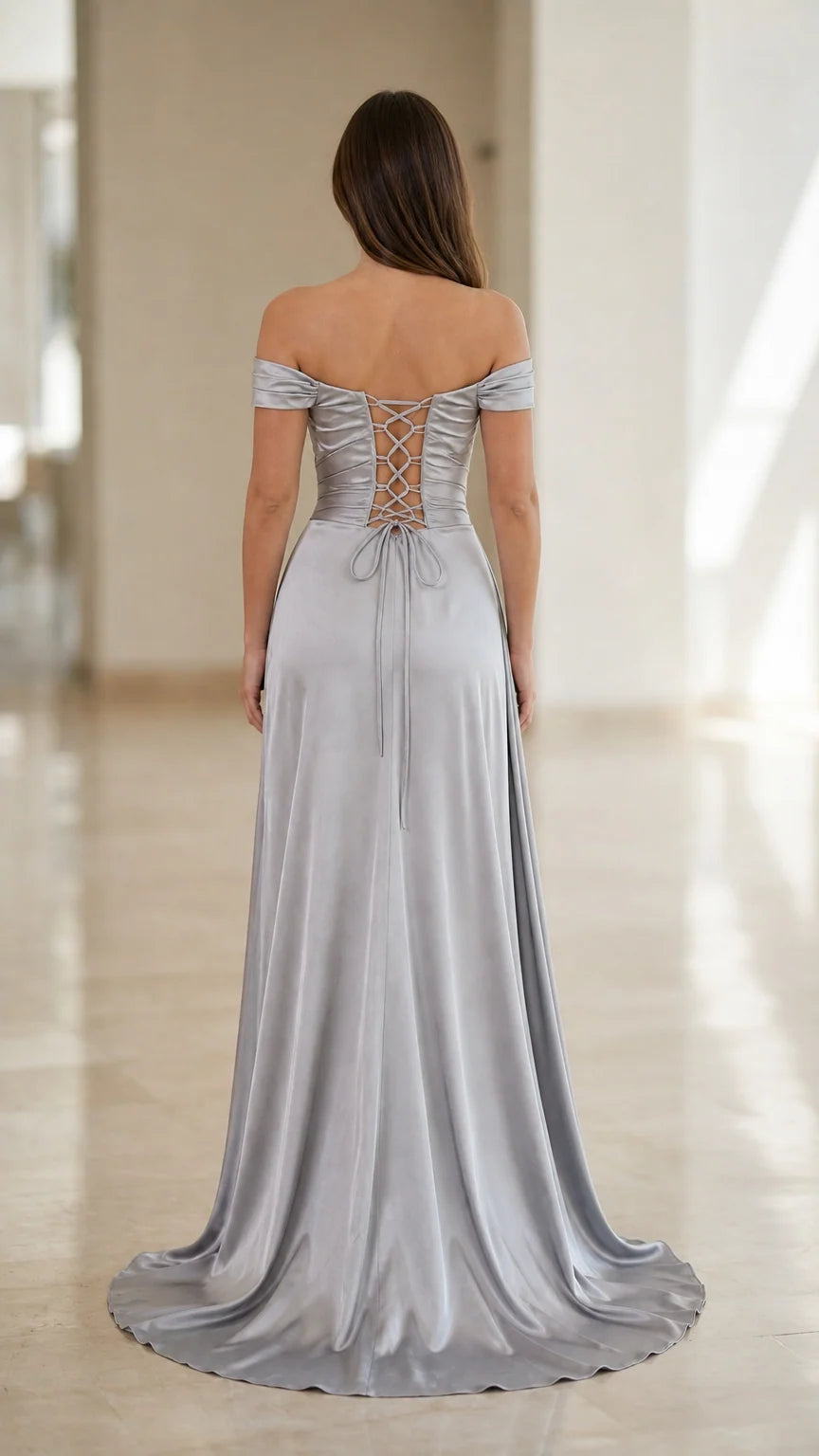 Back view of silver satin gown highlighting adjustable corset lace-up closure