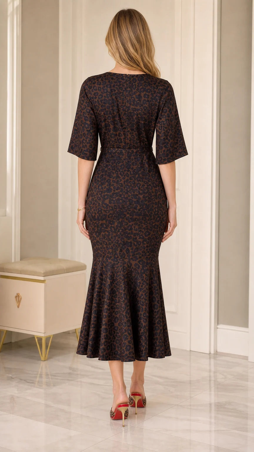 Back view of model wearing Dark Brown animal print midi dress with elbow flutter sleeves