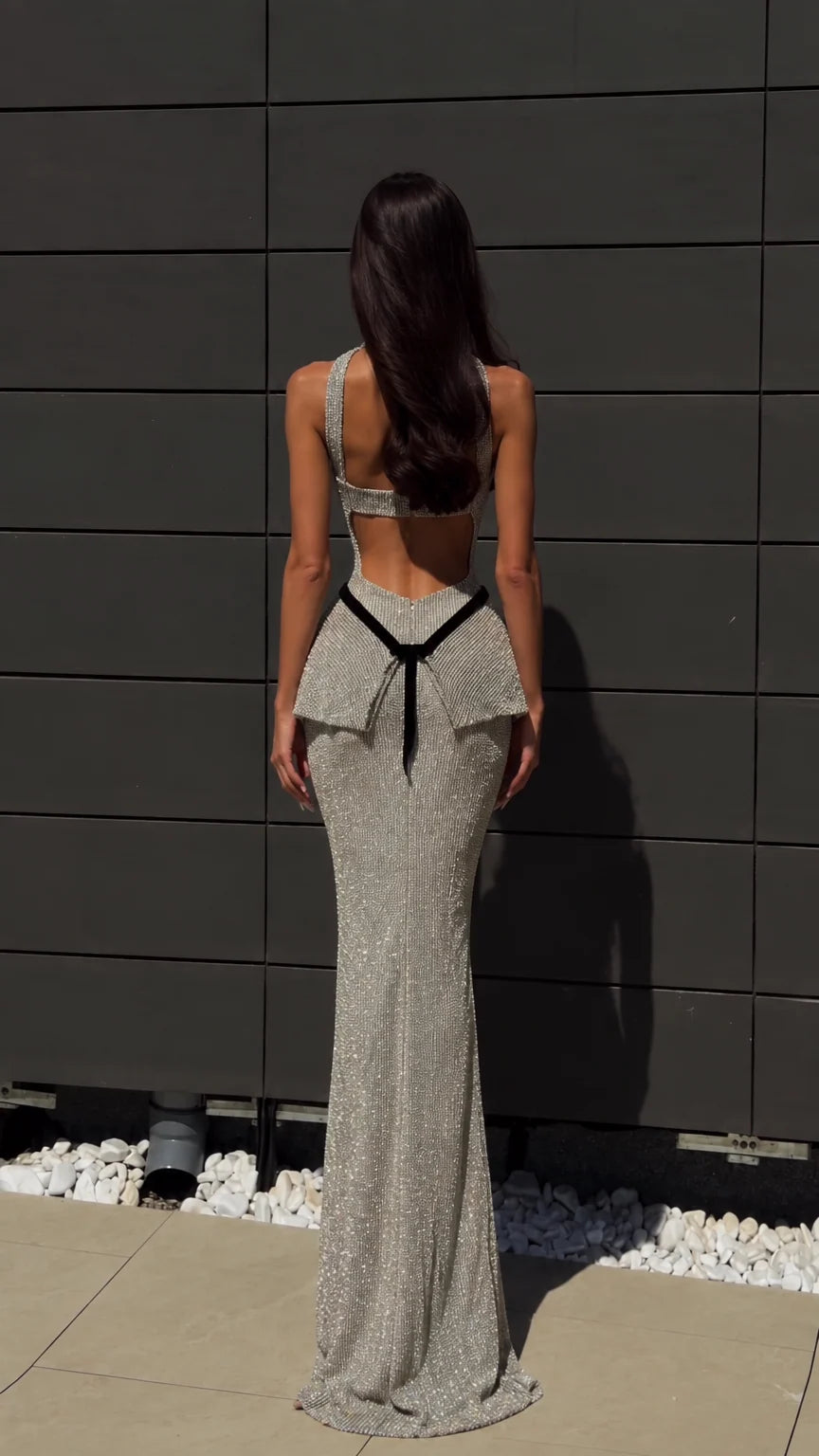 Back view of silver glitter floor-length dress showing open back cutout