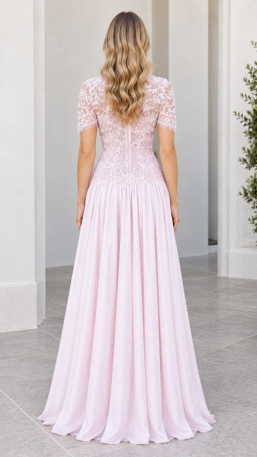Back view of model in floor-length Blush Pink lace bodice evening dress