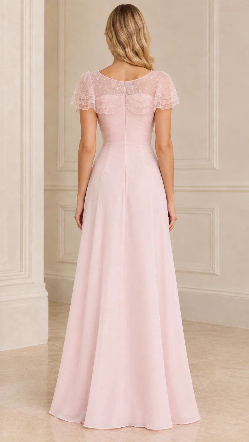Back view of blush pink A-line evening gown with sheer shoulder cape