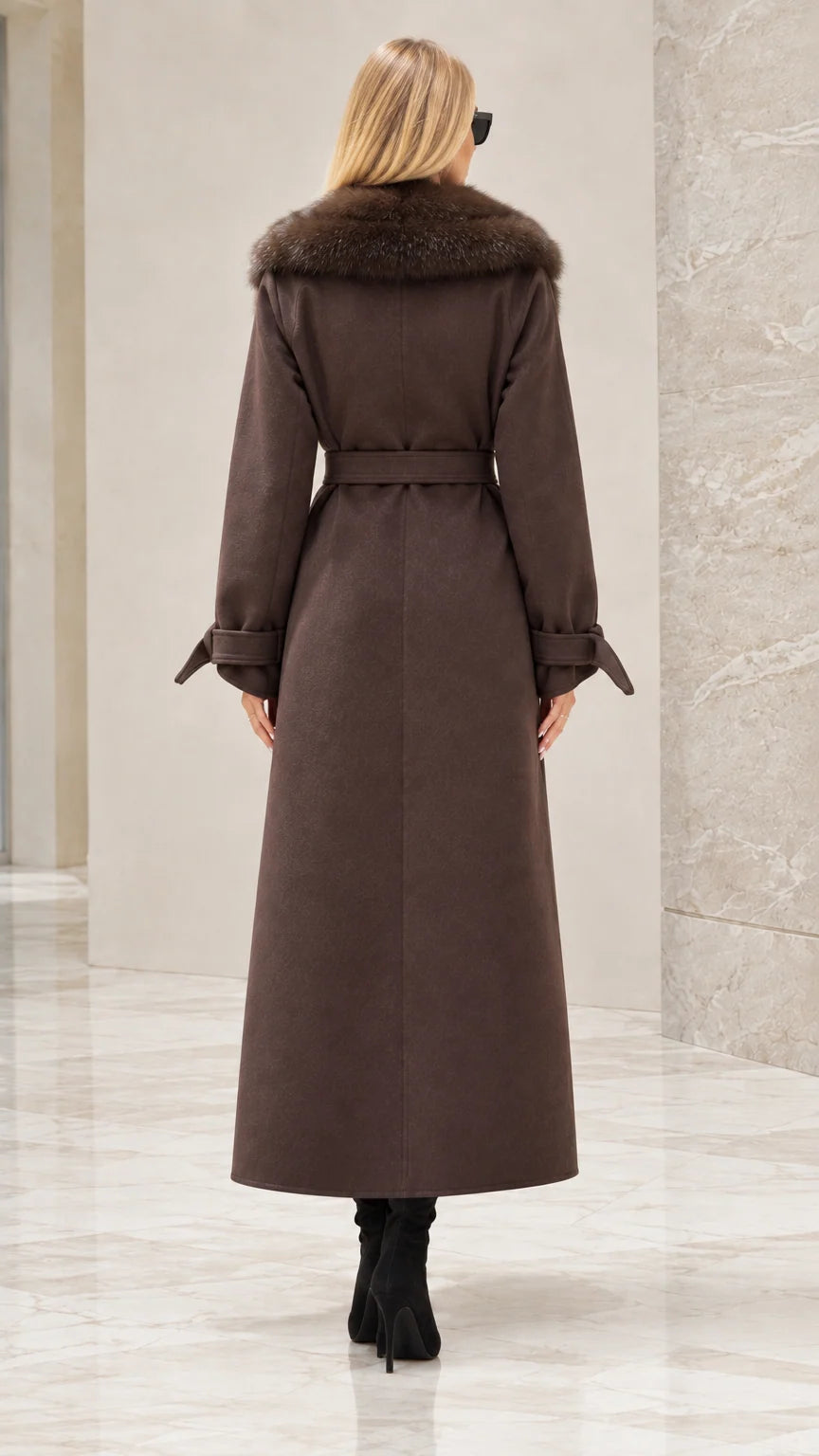Back view of woman wearing brown maxi trench coat with waist tie