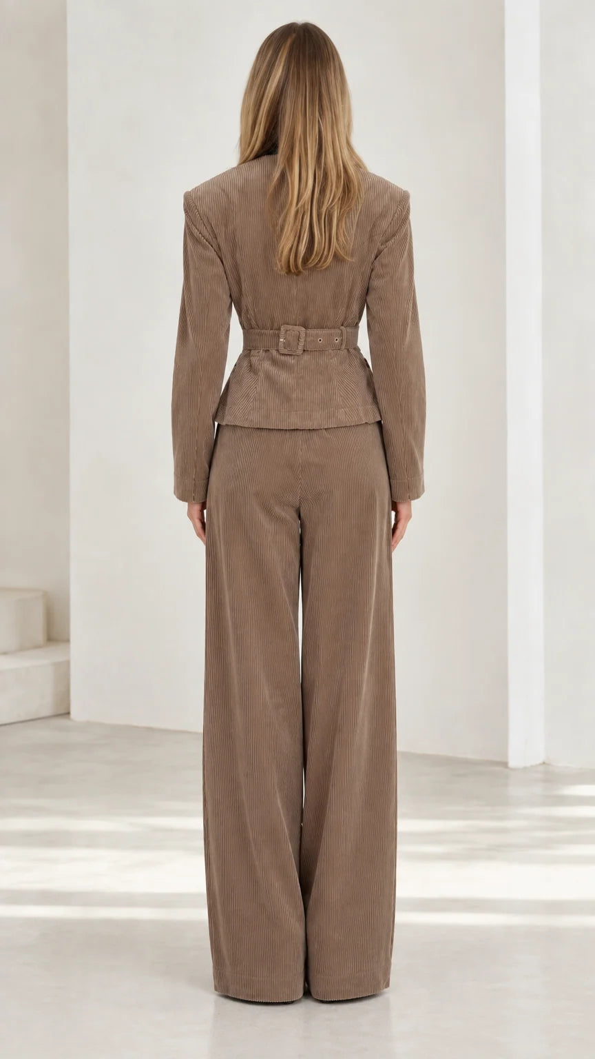 Back view of taupe corduroy suit set highlighting waist detailing and wide trouser fit
