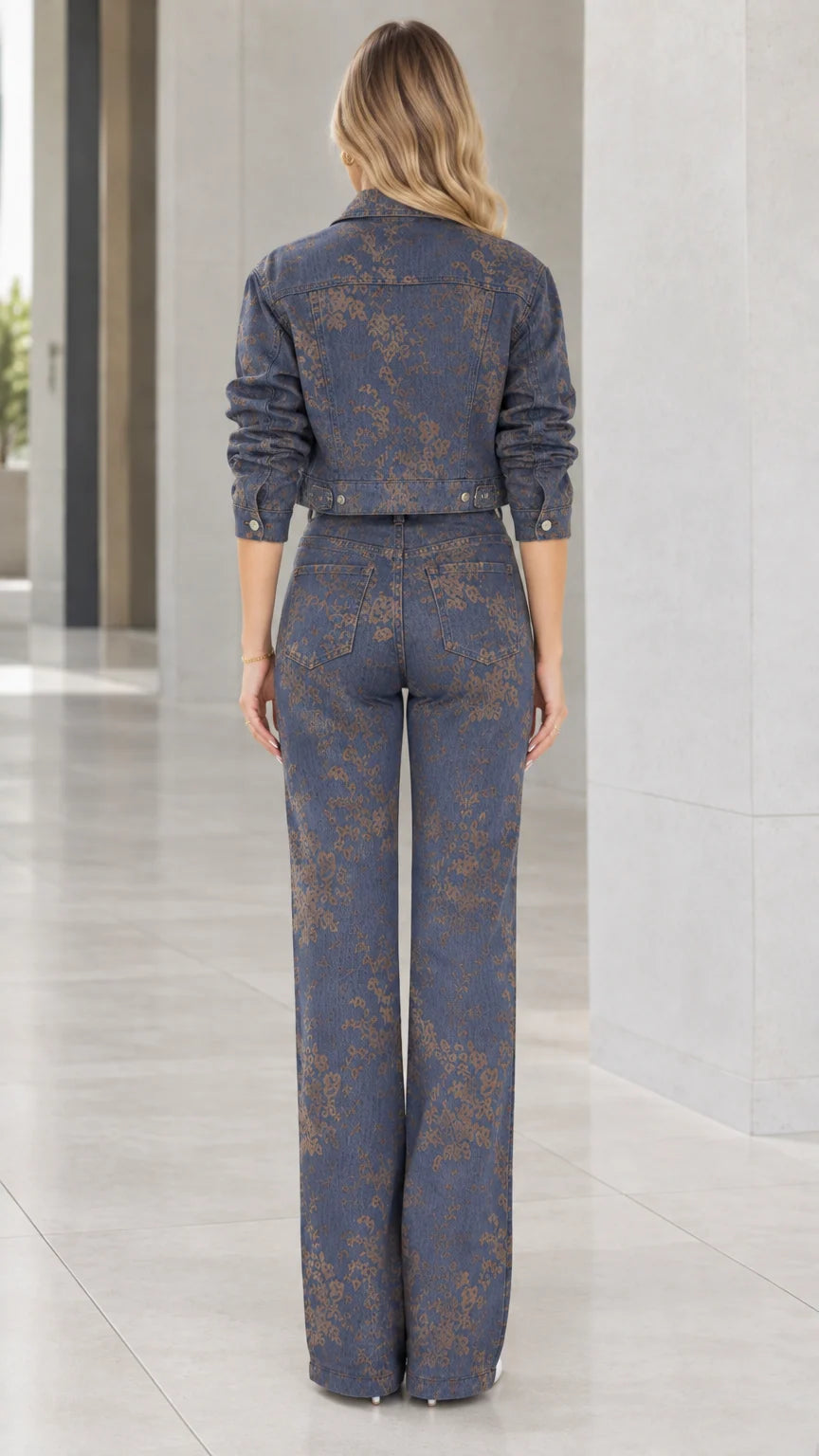 Back view of model wearing Denim Blue floral cropped jacket and high-waisted wide-leg trousers