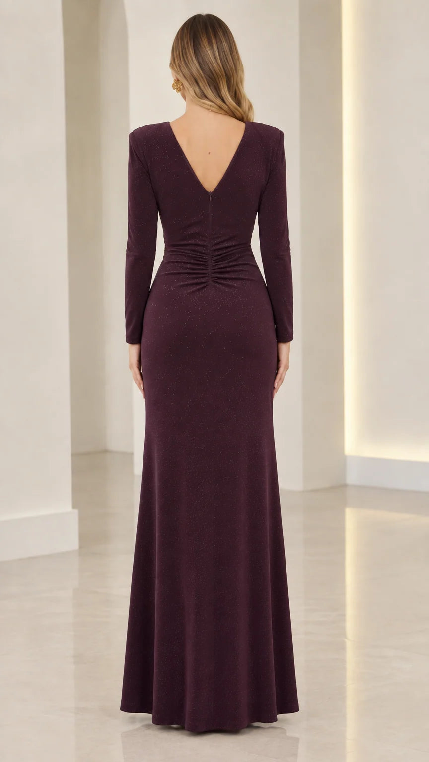 Back view of model showing V-back and ruching on plum maxi formal dress