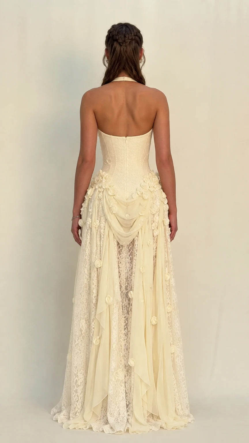 Back view of model in Champagne halter open-back evening gown with lace train