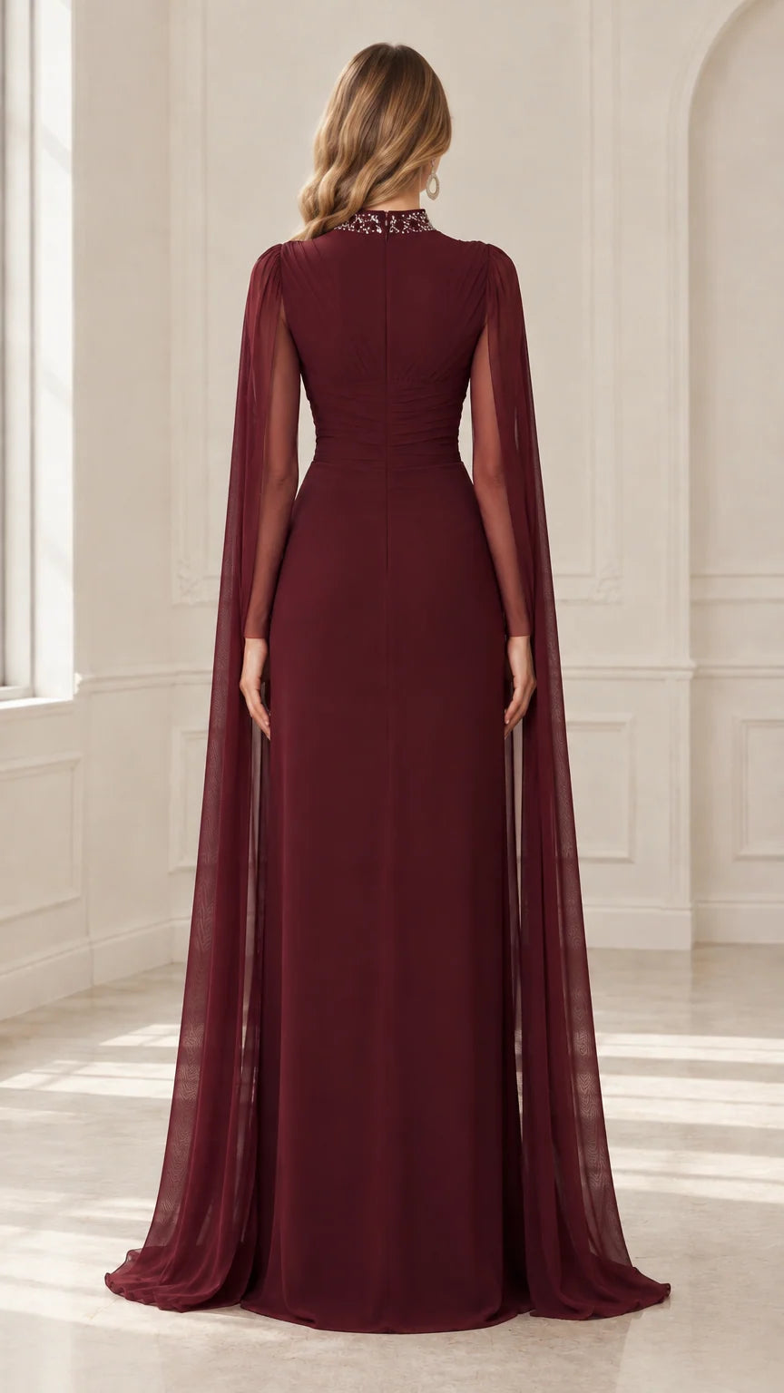 Back view of burgundy maxi gown highlighting full-length cape overlay
