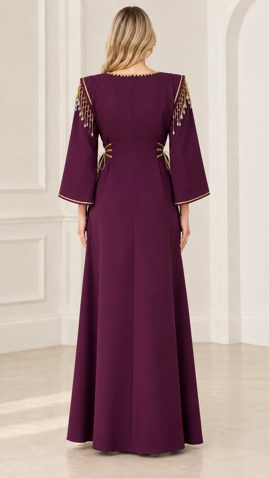 Back view of deep purple maxi dress showing clean tailored lines and shoulder fringe