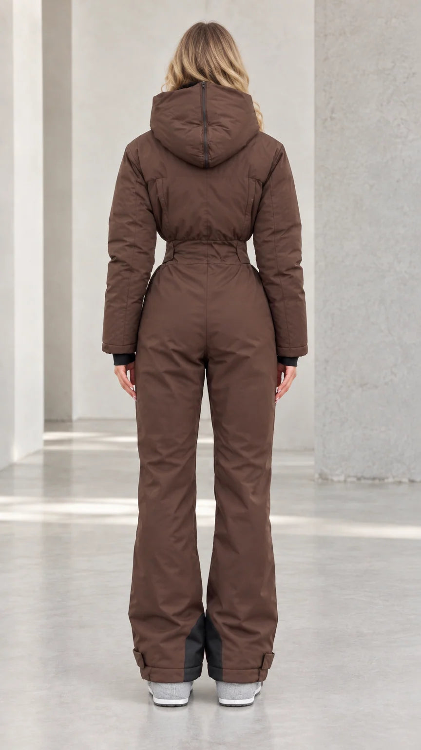 Back view of woman wearing chocolate brown hooded ski suit