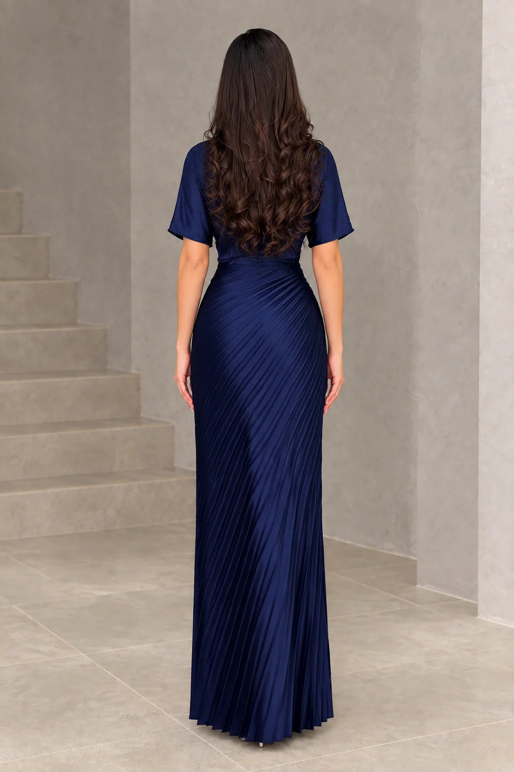Back full-length view of navy blue pleated maxi dress