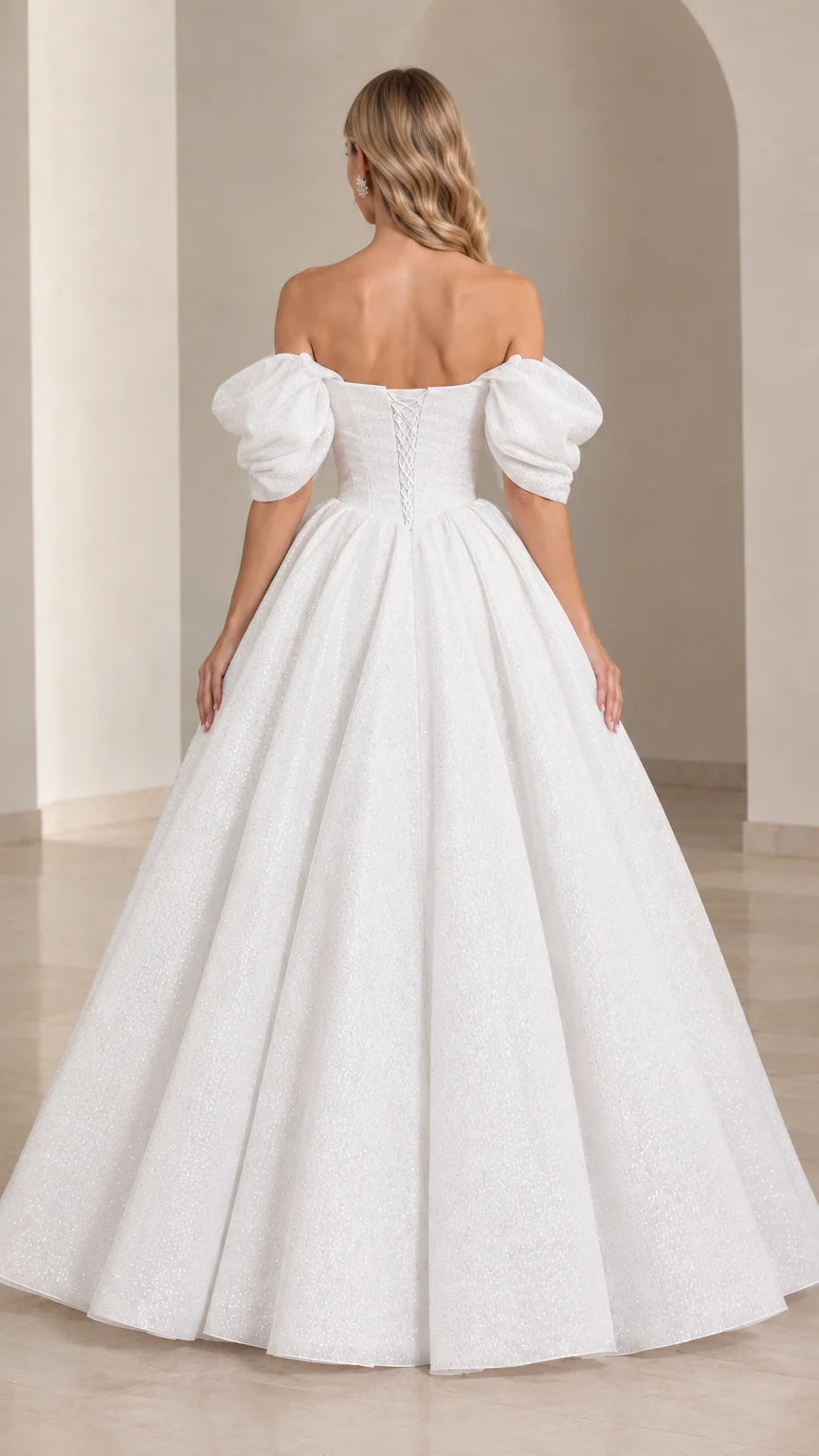 Back view of white formal gown showing lace-up corset detail