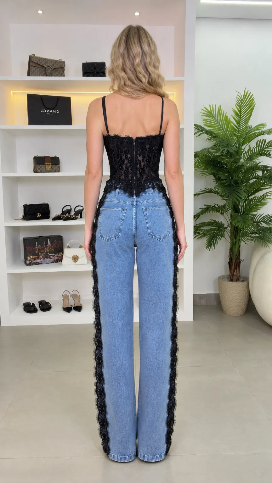 Back view of model in black lace corset top and side lace denim pants
