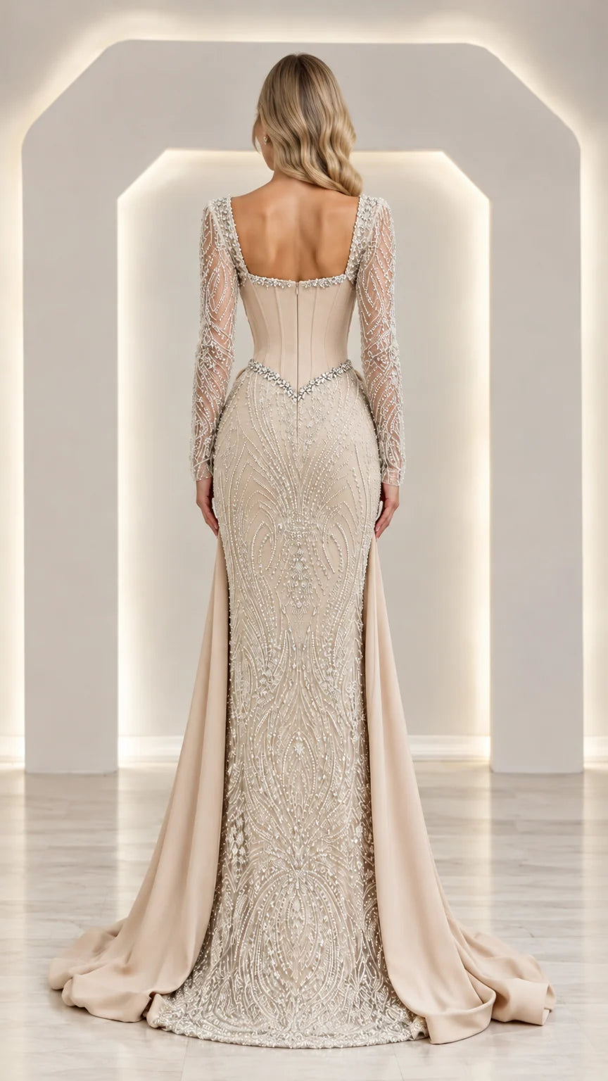 Back view of champagne beaded formal dress showing illusion back and sweeping skirt