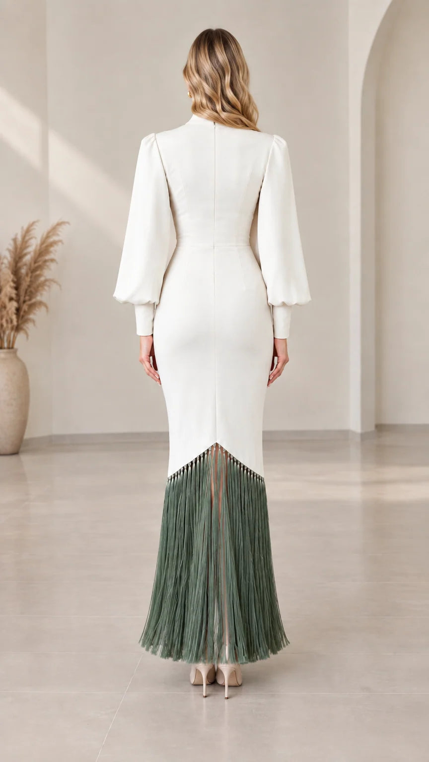 Back view of white long sleeve maxi gown showing tailored fit and fringe hemline