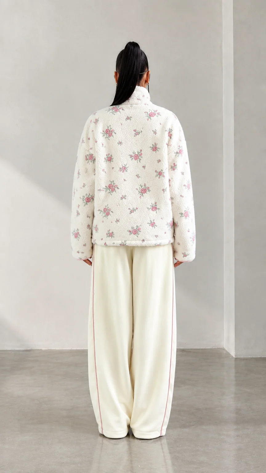 Back view of model wearing cream floral print plush fleece pullover
