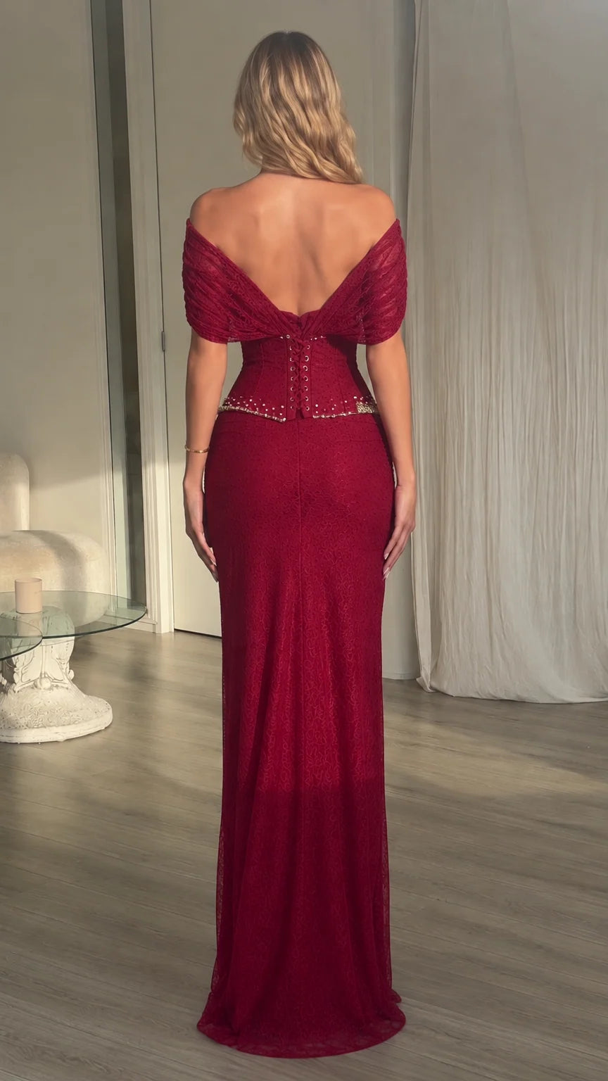 Back view of model wearing burgundy off-the-shoulder draped evening dress