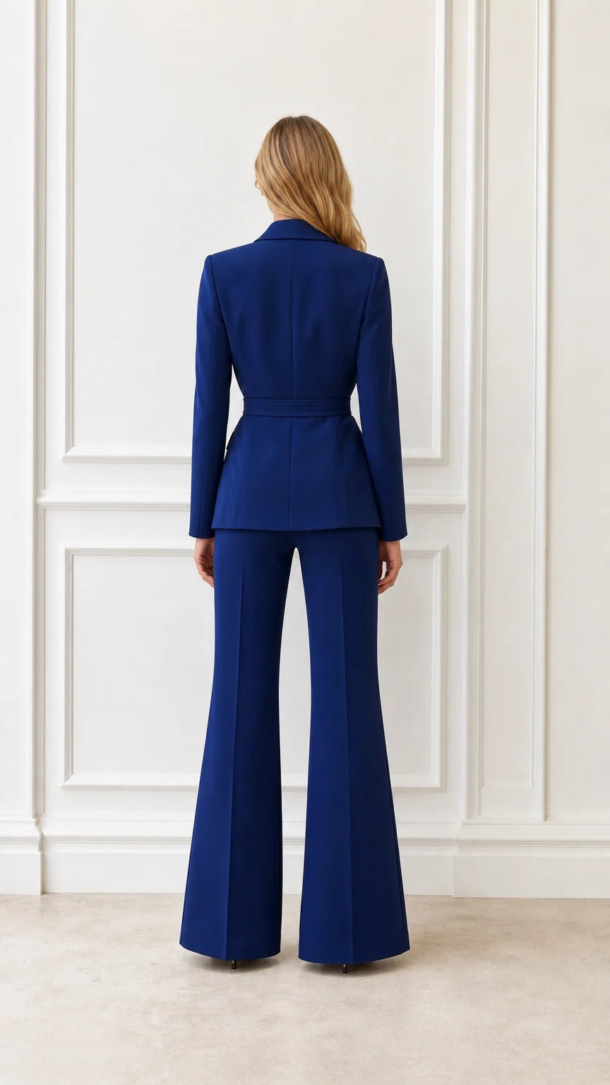 Back view of woman wearing royal blue suit set with flared trousers
