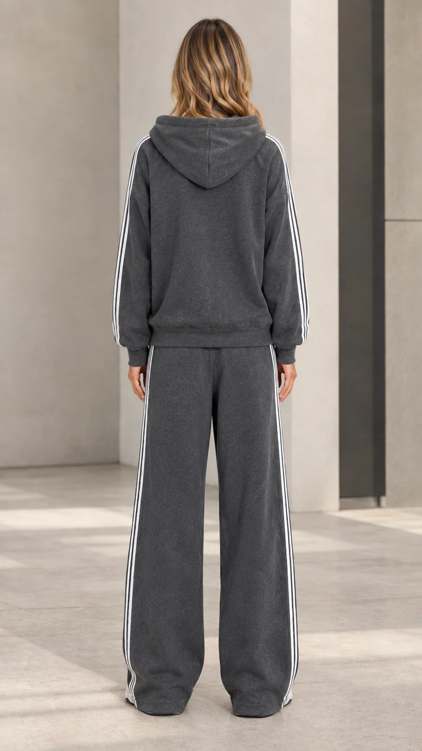 Back view of model wearing charcoal grey hooded sweatshirt and wide-leg sweatpants set