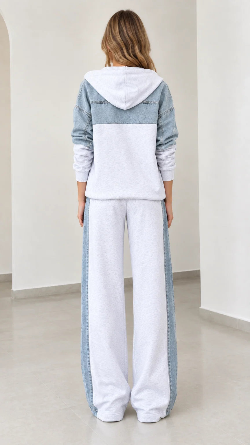 Back view of model wearing heather grey zip hoodie with denim back yoke and matching sweatpants