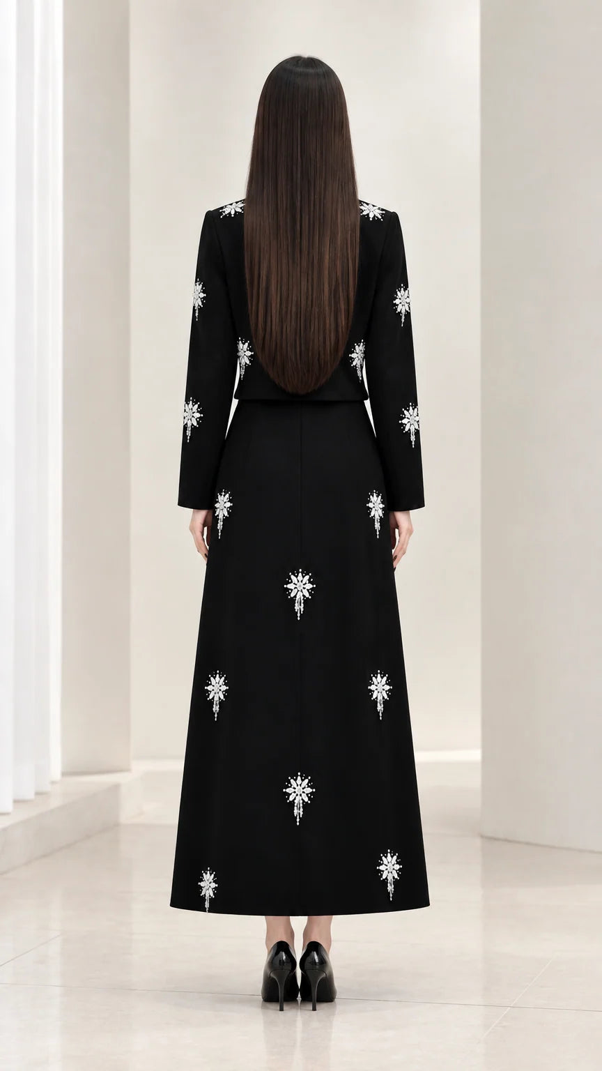 Back view of black long sleeve top and maxi skirt set