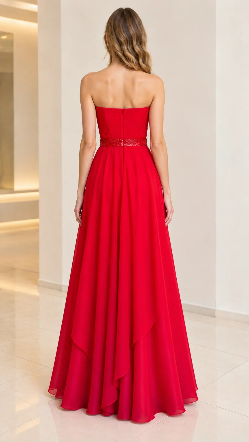 Back view of woman wearing strapless red evening dress with flowing skirt