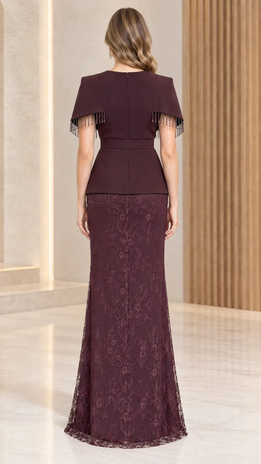 Back view of burgundy lace evening gown showing zipper and capelet overlay