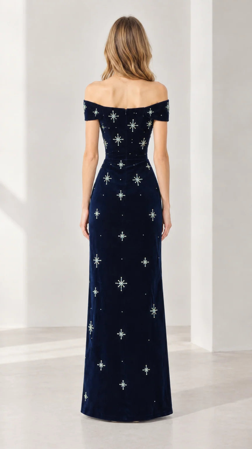 Back view of navy blue off-the-shoulder velvet maxi dress showing fitted silhouette and rear zipper