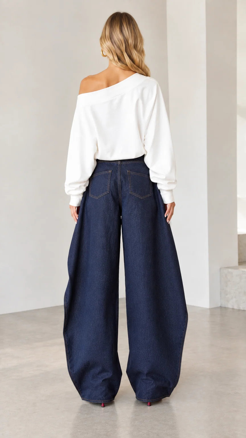 Back view of women wearing high-rise dark blue wide-leg denim pants with classic rear pockets