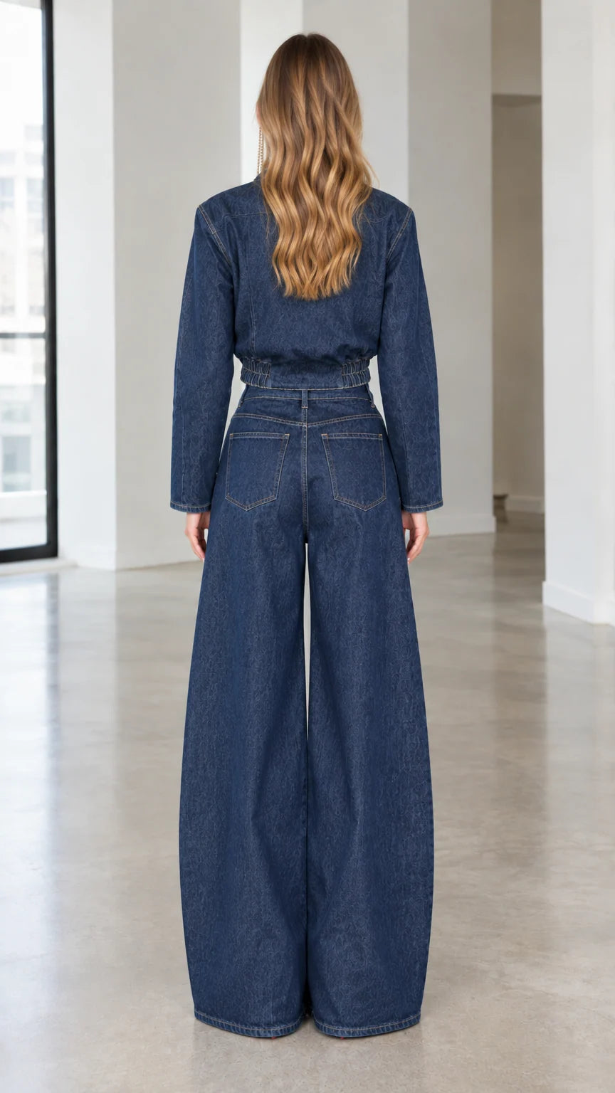 Back view of model in dark blue denim wrap jacket and high waist wide leg jeans