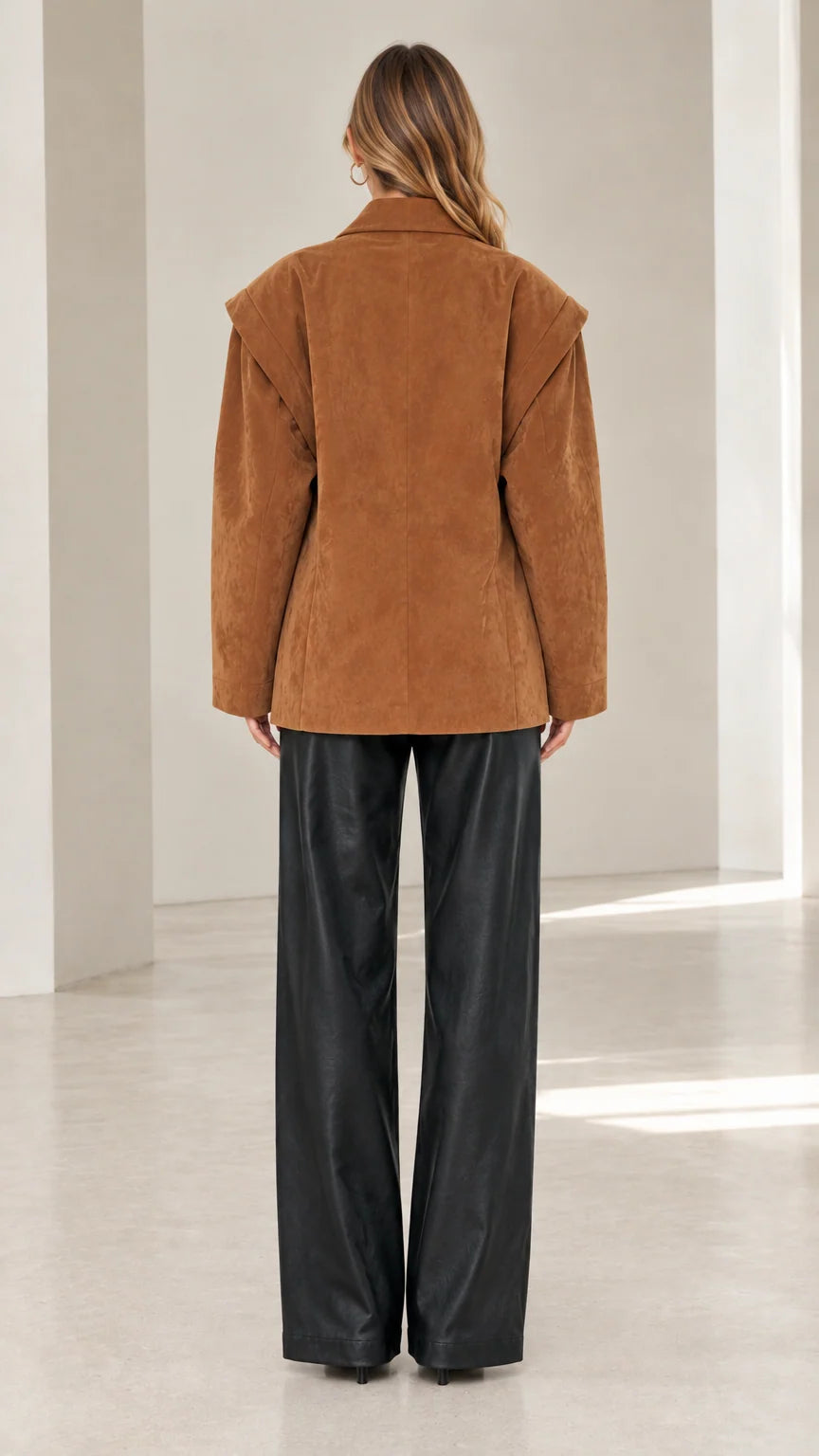 Back view of model in camel faux suede blazer highlighting shoulder overlay construction