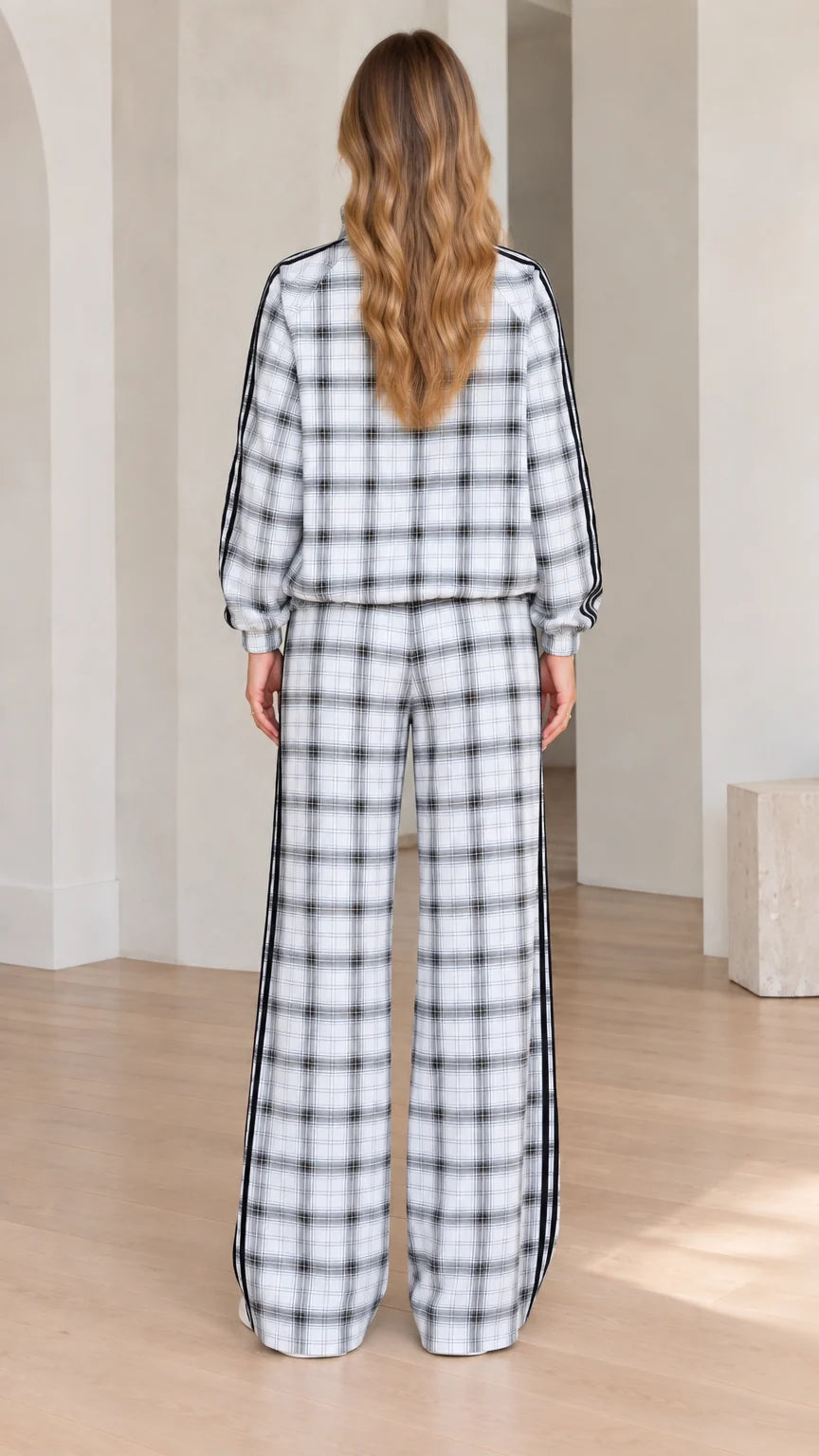 Back view of women's plaid tracksuit showing relaxed fit jacket and trousers