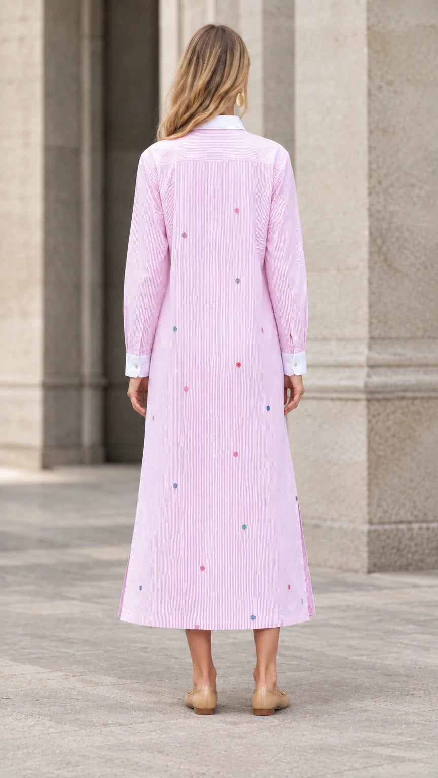 Back view of woman wearing pink striped embroidered maxi shirt dress