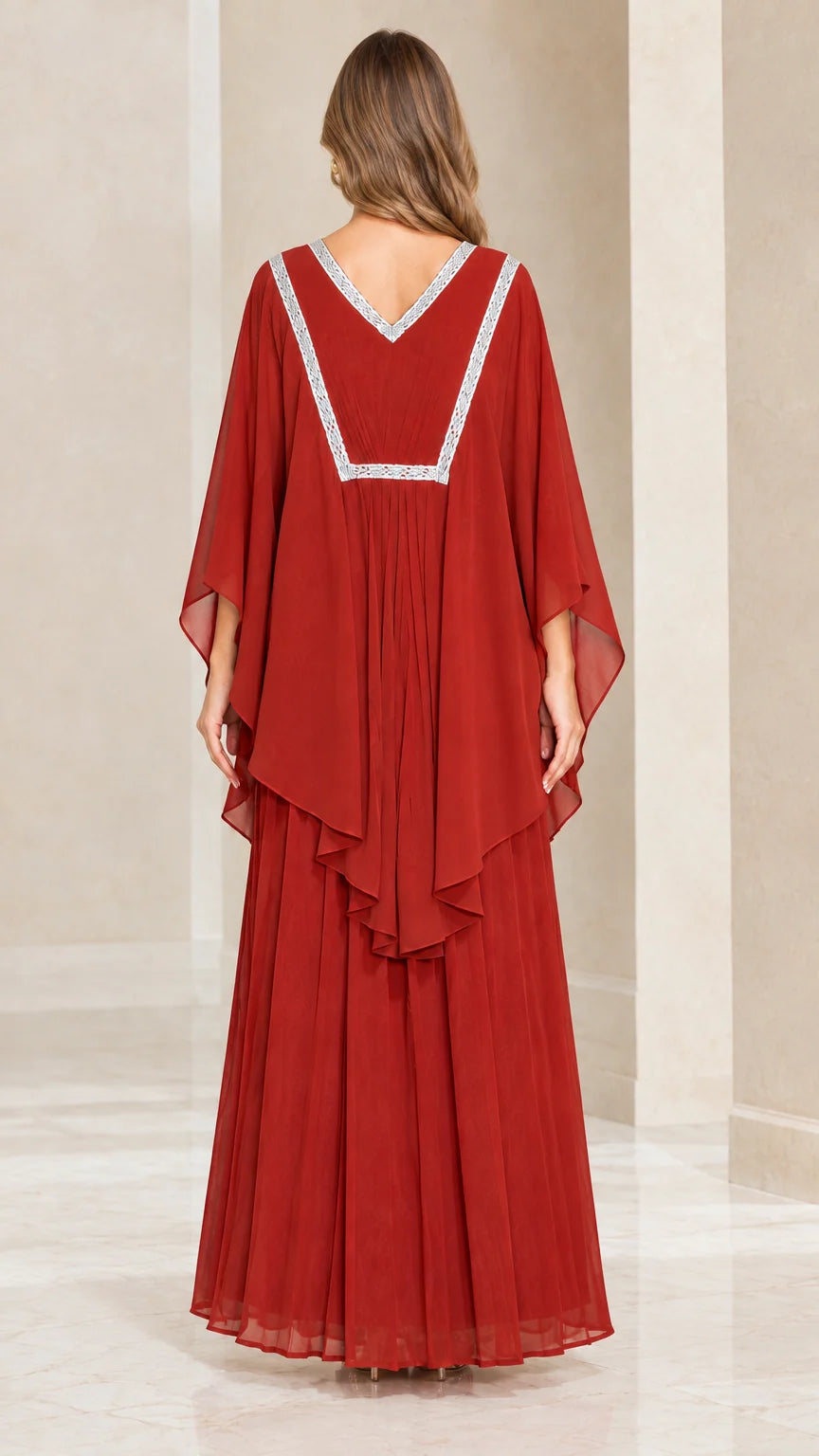 Back view of rust red maxi dress displaying embroidered V-back neckline and layered drape