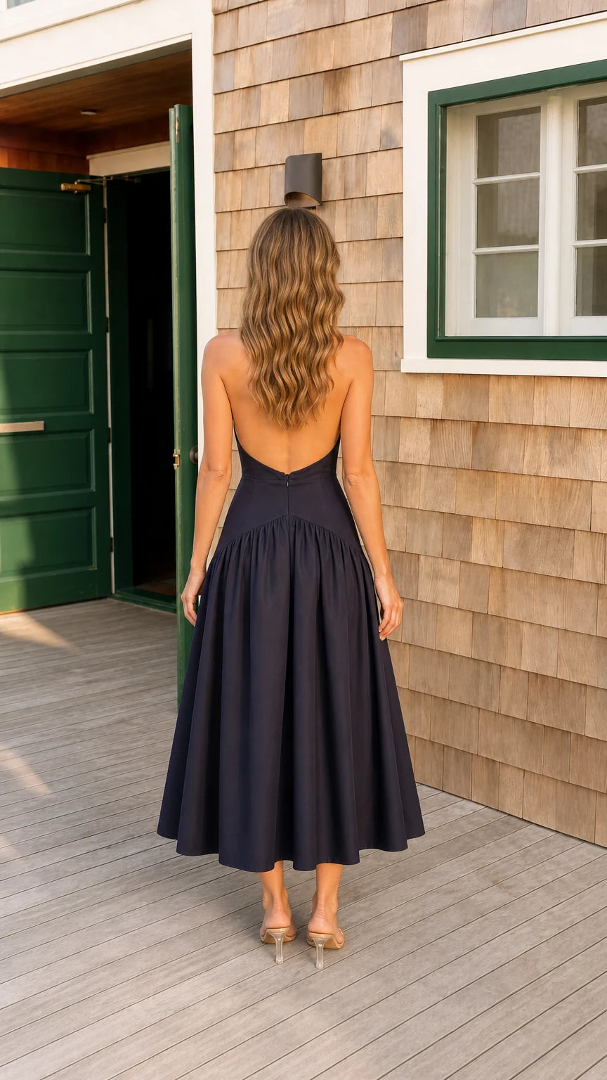 Back view of navy blue open back drop waist pleated midi dress