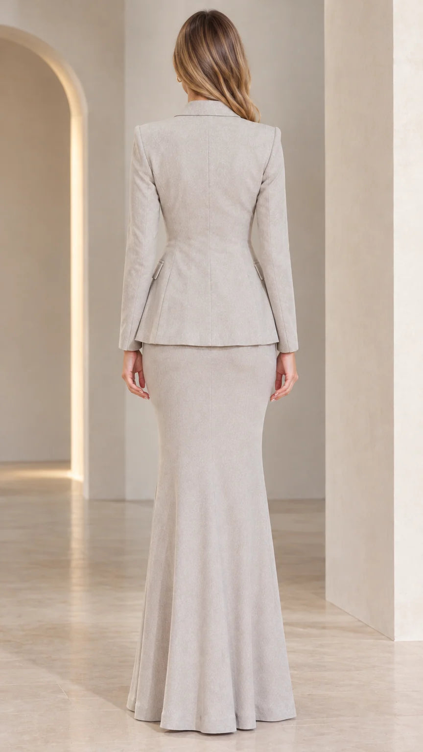 Back view of model in Light Grey long fishtail skirt and tailored blazer set