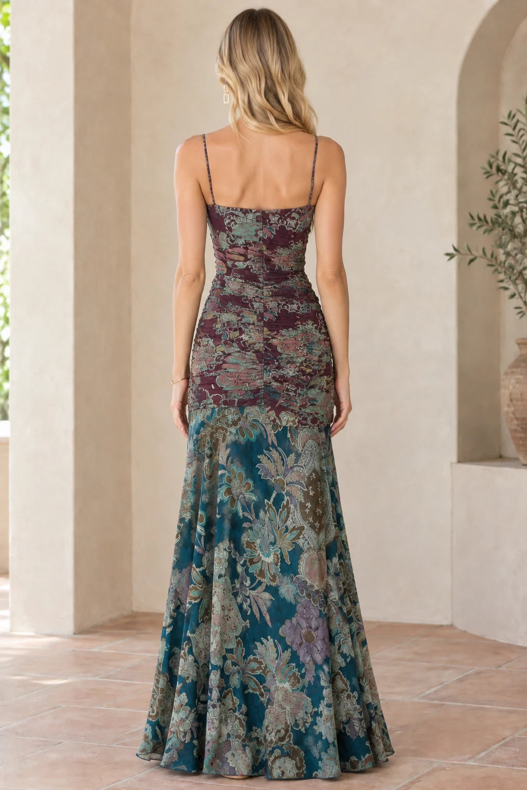 Back view of model wearing burgundy floral spaghetti strap floor-length dress