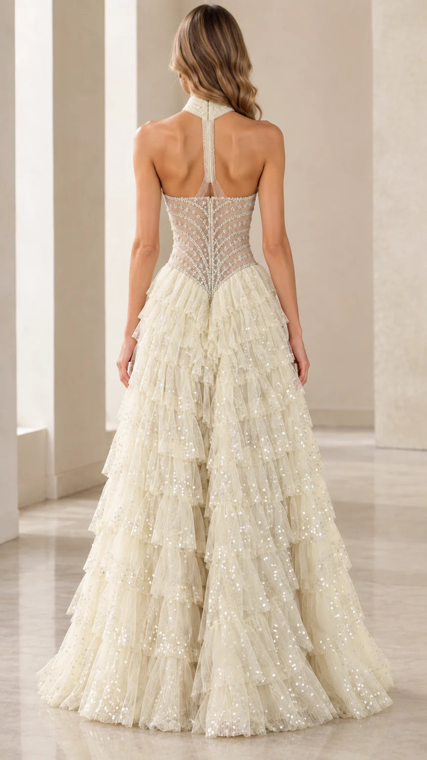 Model wearing an Ivory halter neck beaded tulle formal gown back view