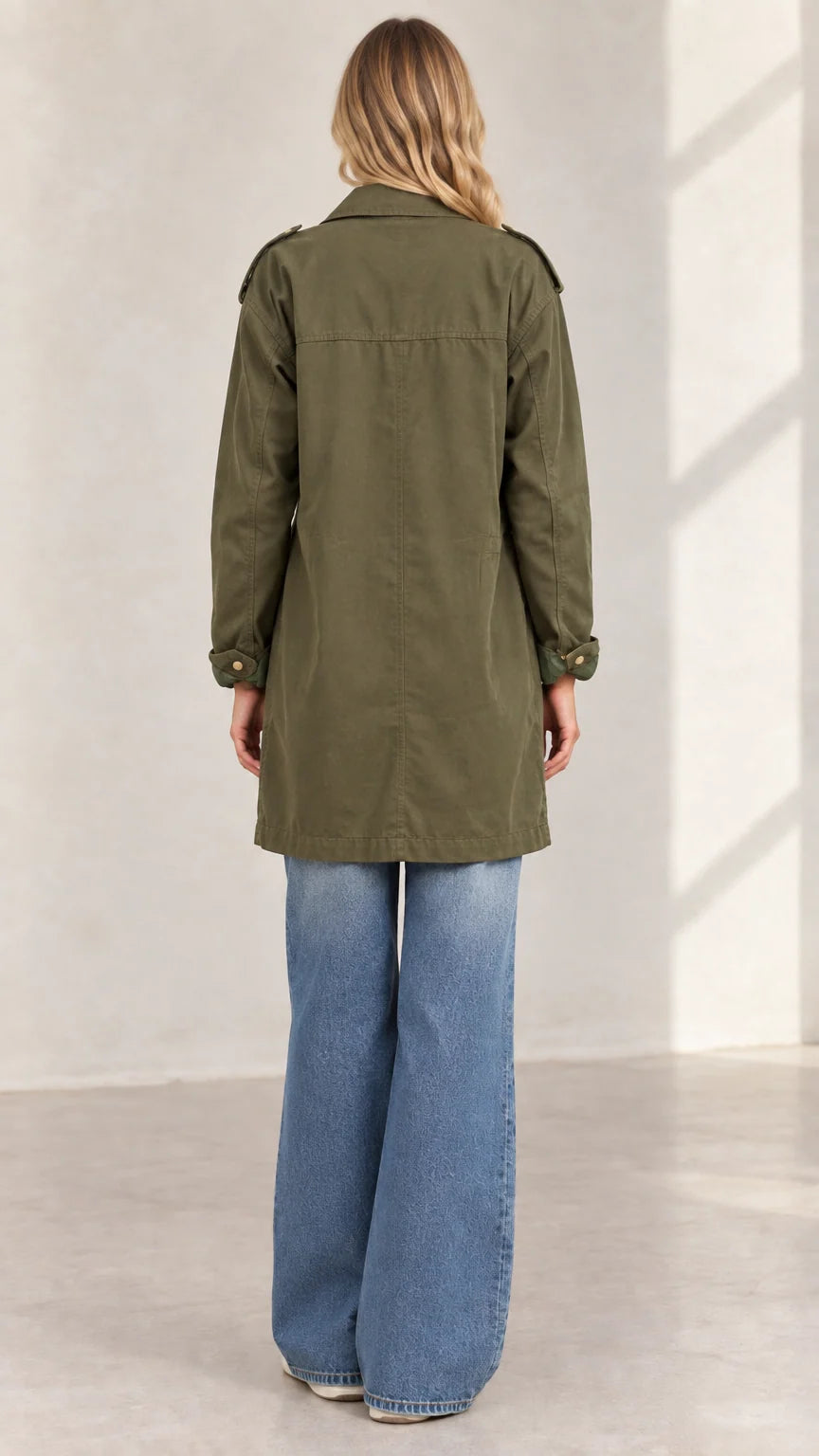 Back view of women's army green casual mid-length cargo jacket