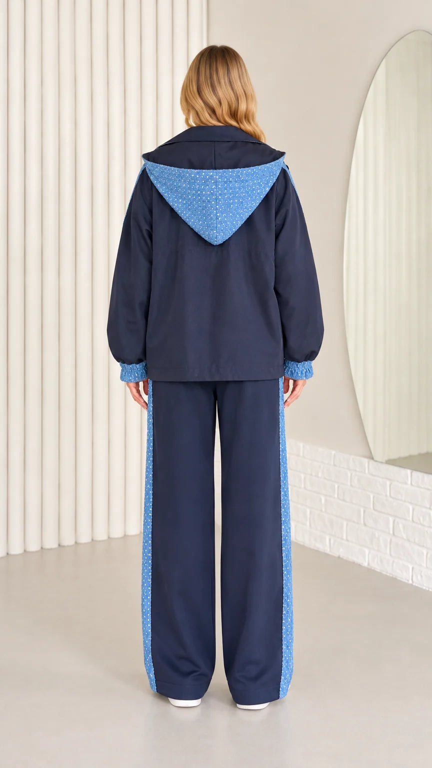 Back view of navy blue hooded jacket with sequin hood detail and matching pants