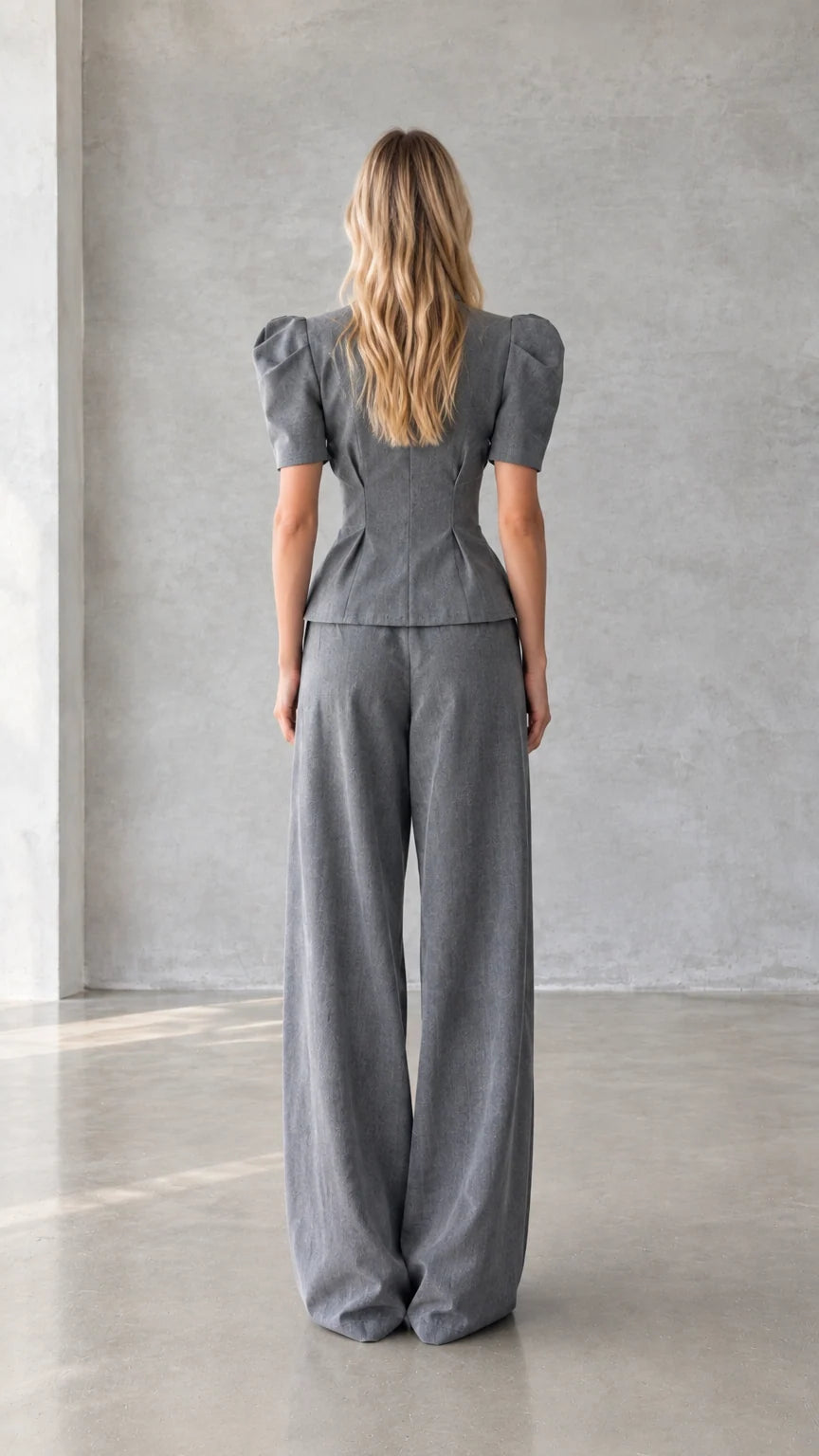 Back view of grey peplum top and wide leg trousers set