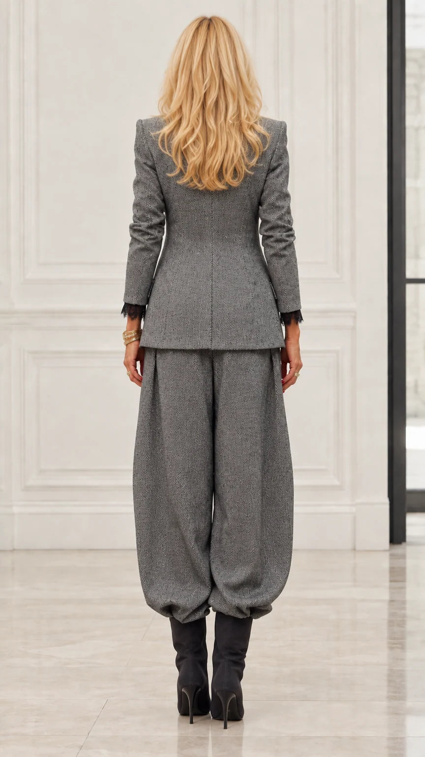 Back view of model in Grey textured blazer and tapered trousers