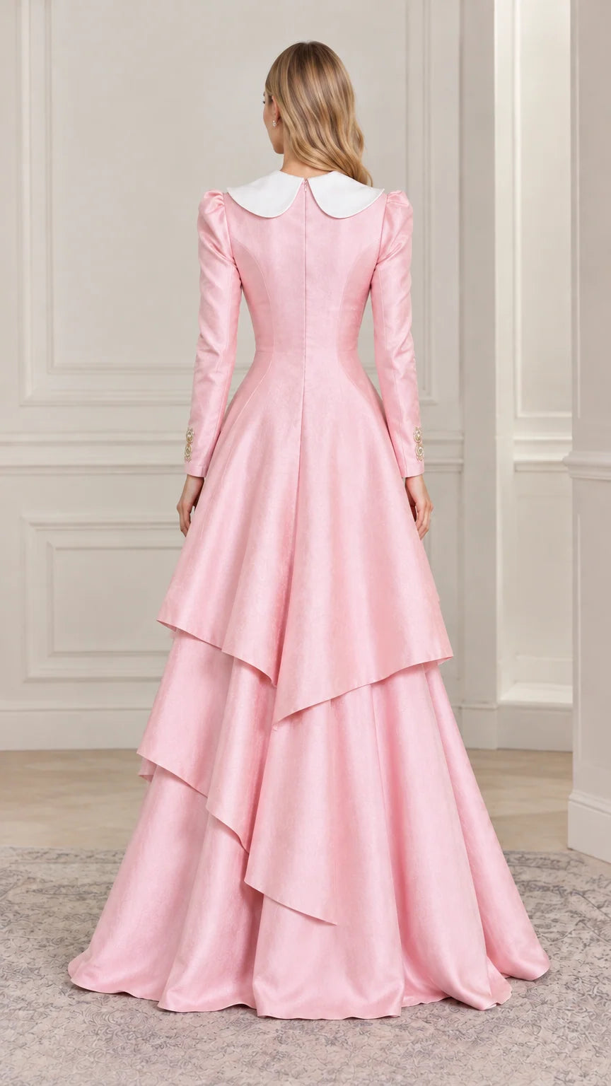 Back full-length view of woman showing cascading layered skirt on pink formal dress
