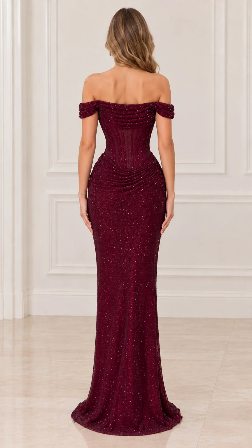 Back view of woman wearing fitted burgundy off-the-shoulder evening dress