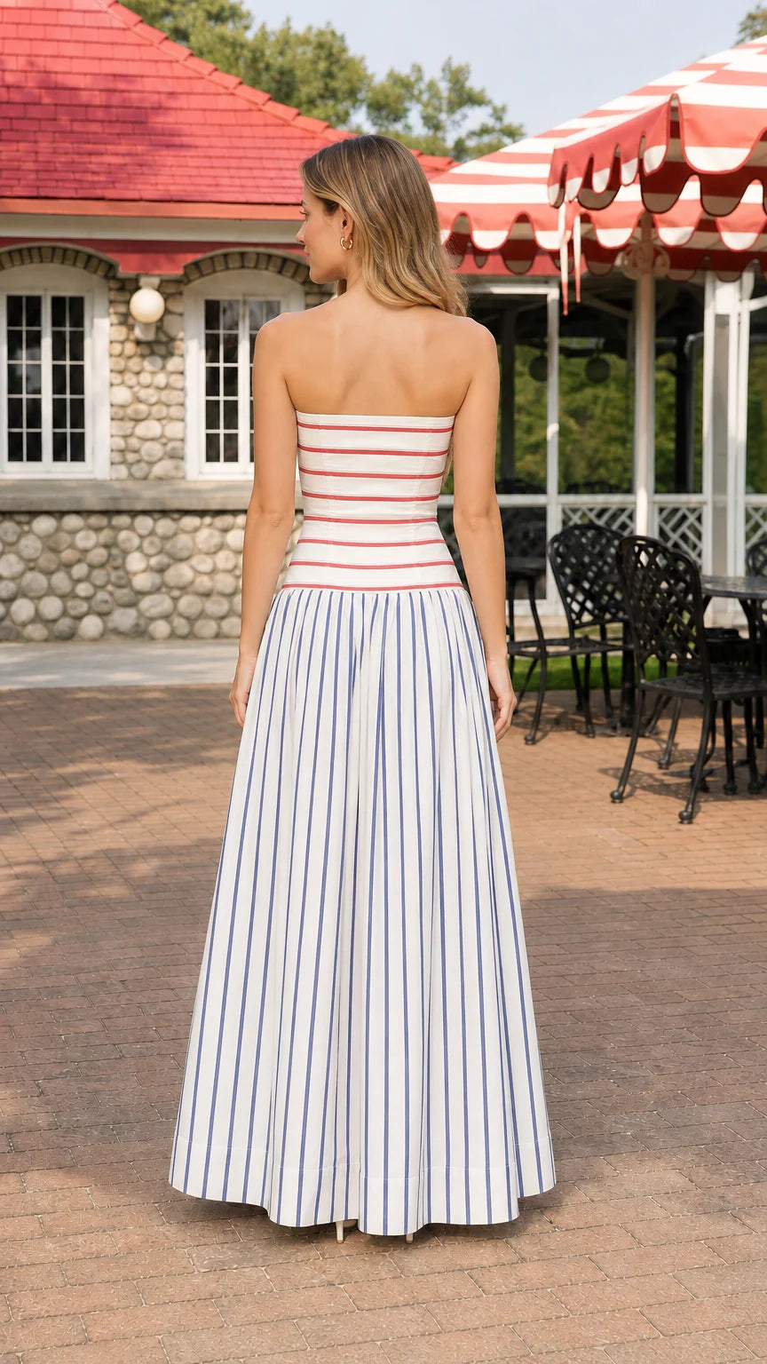 Model wearing blue and white striped strapless maxi dress, back view