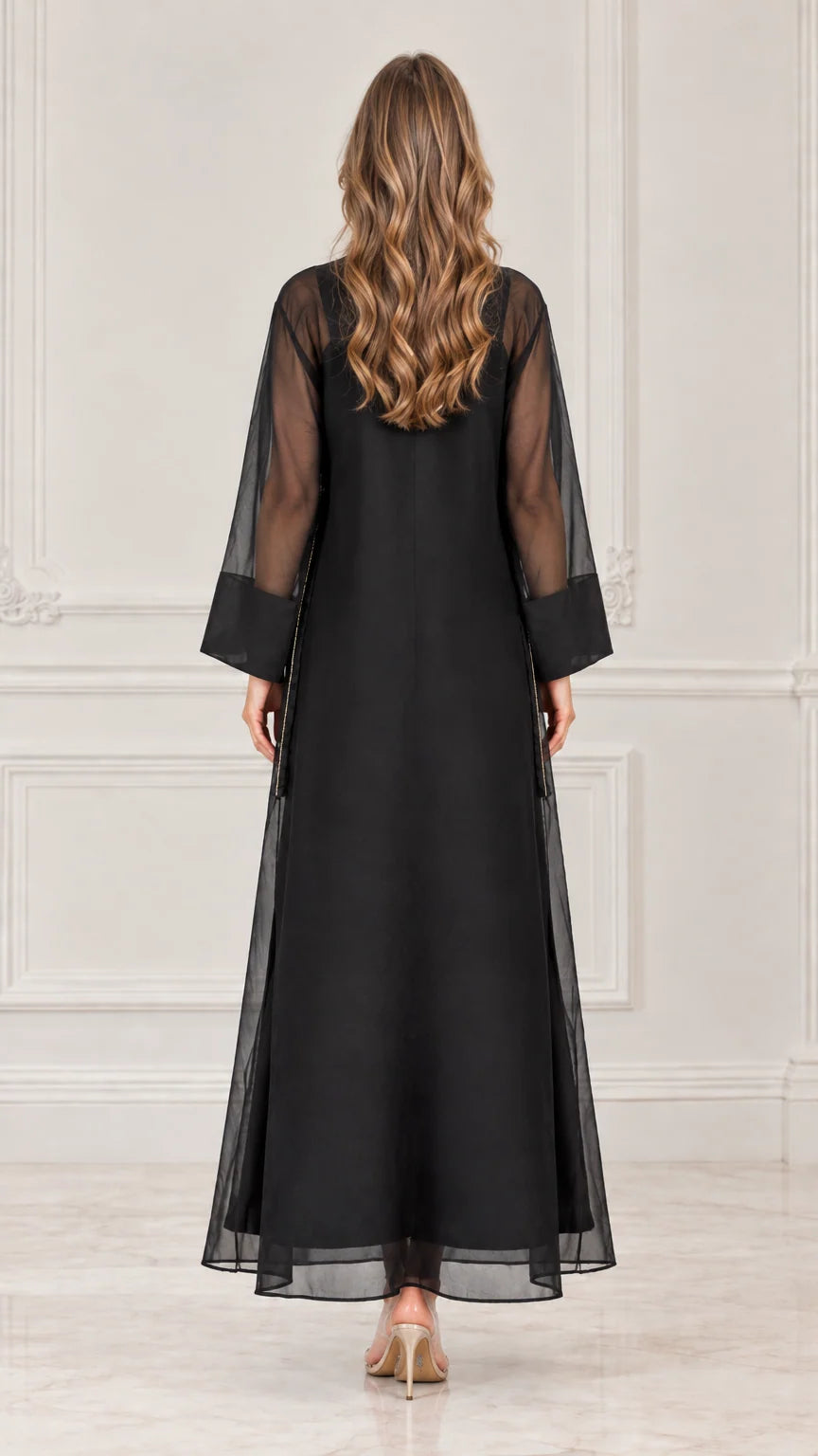 Back view of model wearing black sheer overlay long sleeve maxi dress
