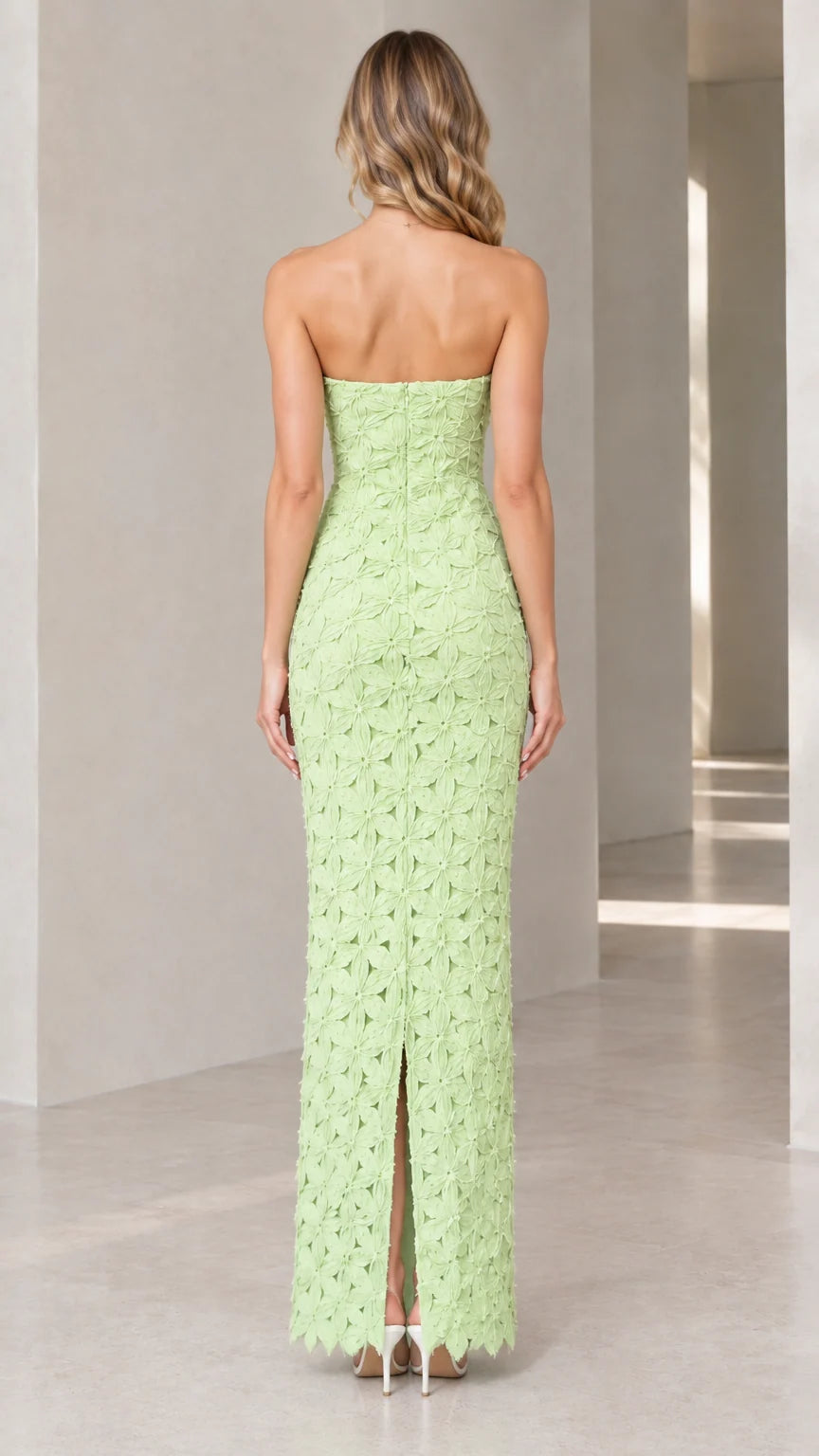 Back view of mint green strapless floral column dress showing center back slit