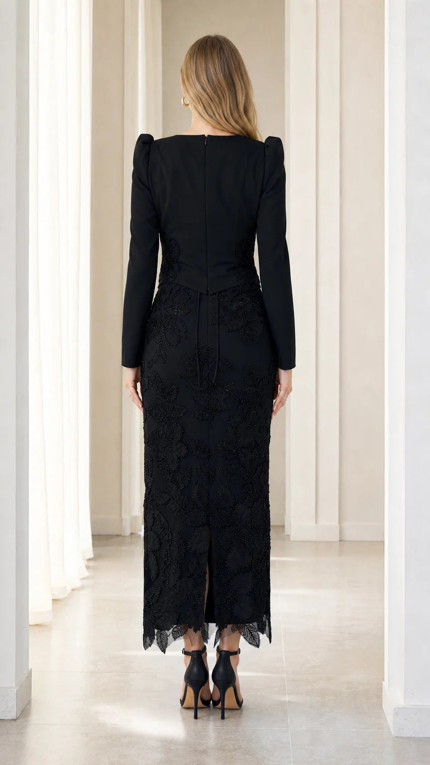 Back view of black column evening gown showing back slit and smooth fit