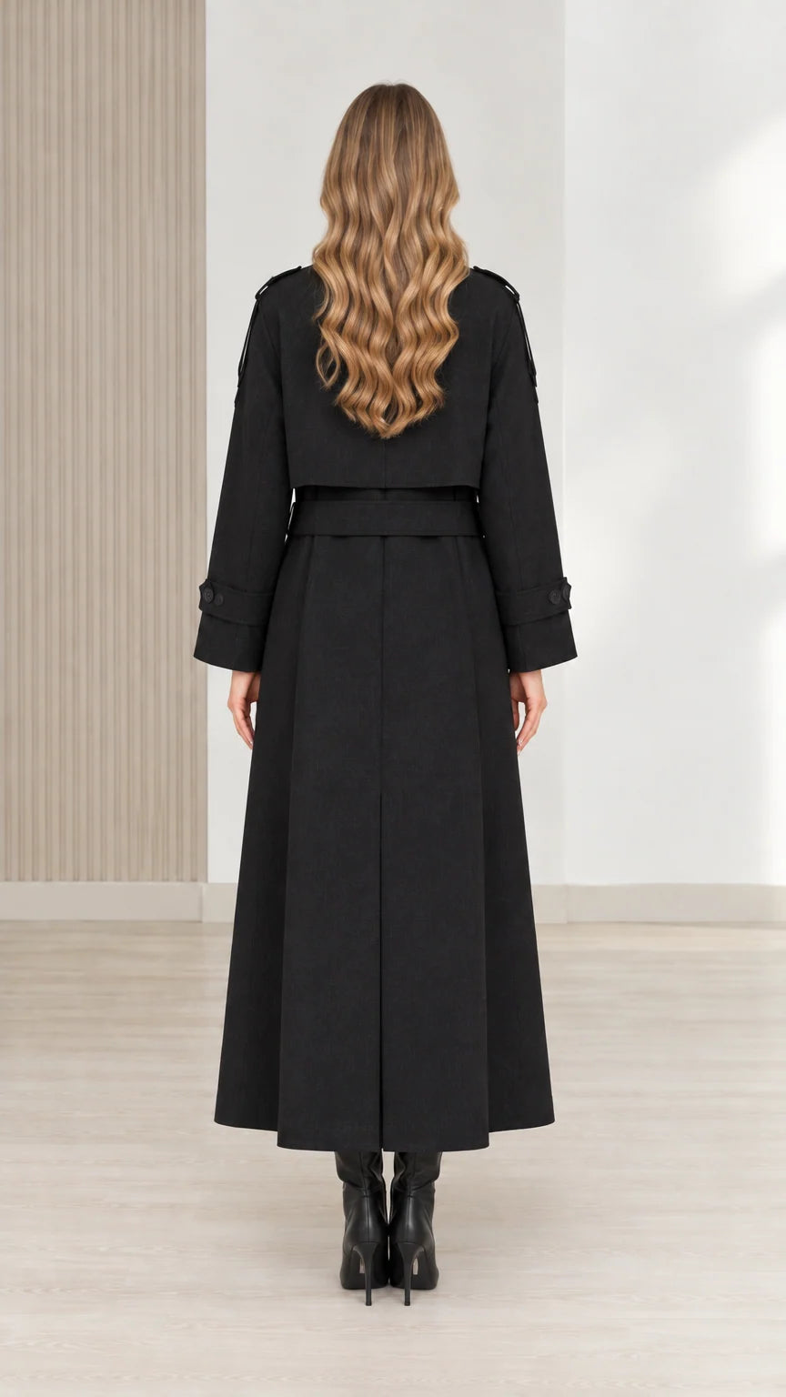 Back view of women's black full-length trench coat